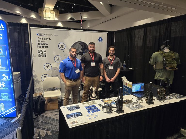 Dakota and Palo at a trade show with two other Persistent team-members